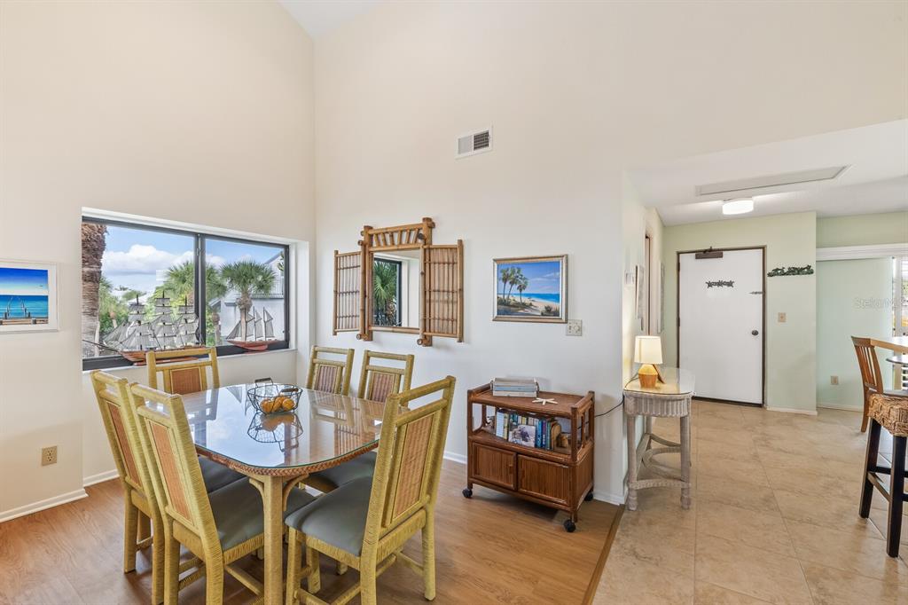 5000 Gasparilla Road, Unit 76B Boca Grande, FL 33921 - Photo 15 of 44 a view of a dining room with furniture window and wooden floor