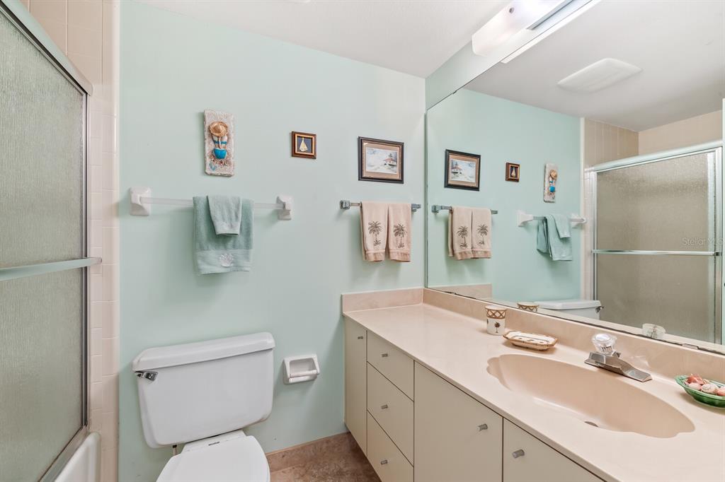 5000 Gasparilla Road, Unit 76B Boca Grande, FL 33921 - Photo 20 of 44 a bathroom with a toilet sink and mirror