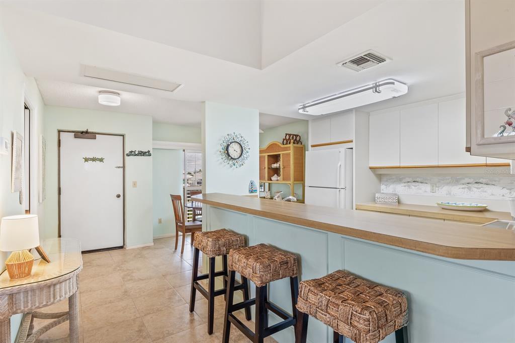 5000 Gasparilla Road, Unit 76B Boca Grande, FL 33921 - Photo 10 of 44 a dining room with furniture and window