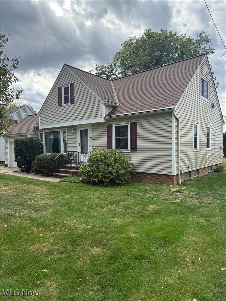 1284 Haverston Road Lyndhurst, OH 44124 - Photo 2 of 43 View of front of property with a shingled roof, a front yard, and a garage