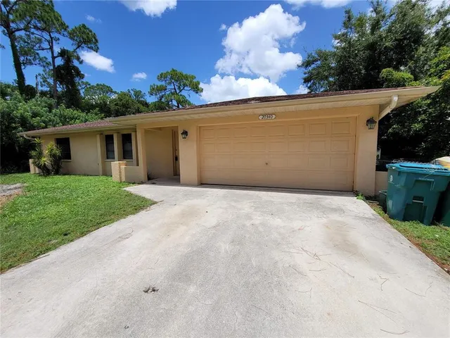 a view of a garage with a house