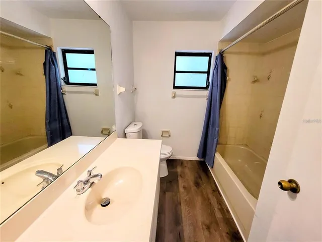 a bedroom with a bed and a ceiling fan