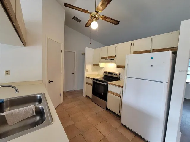 a kitchen with a refrigerator a sink and dishwasher