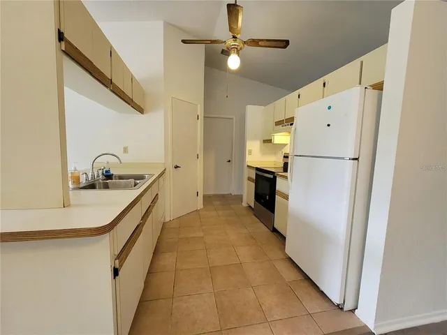 a kitchen with a refrigerator and a stove