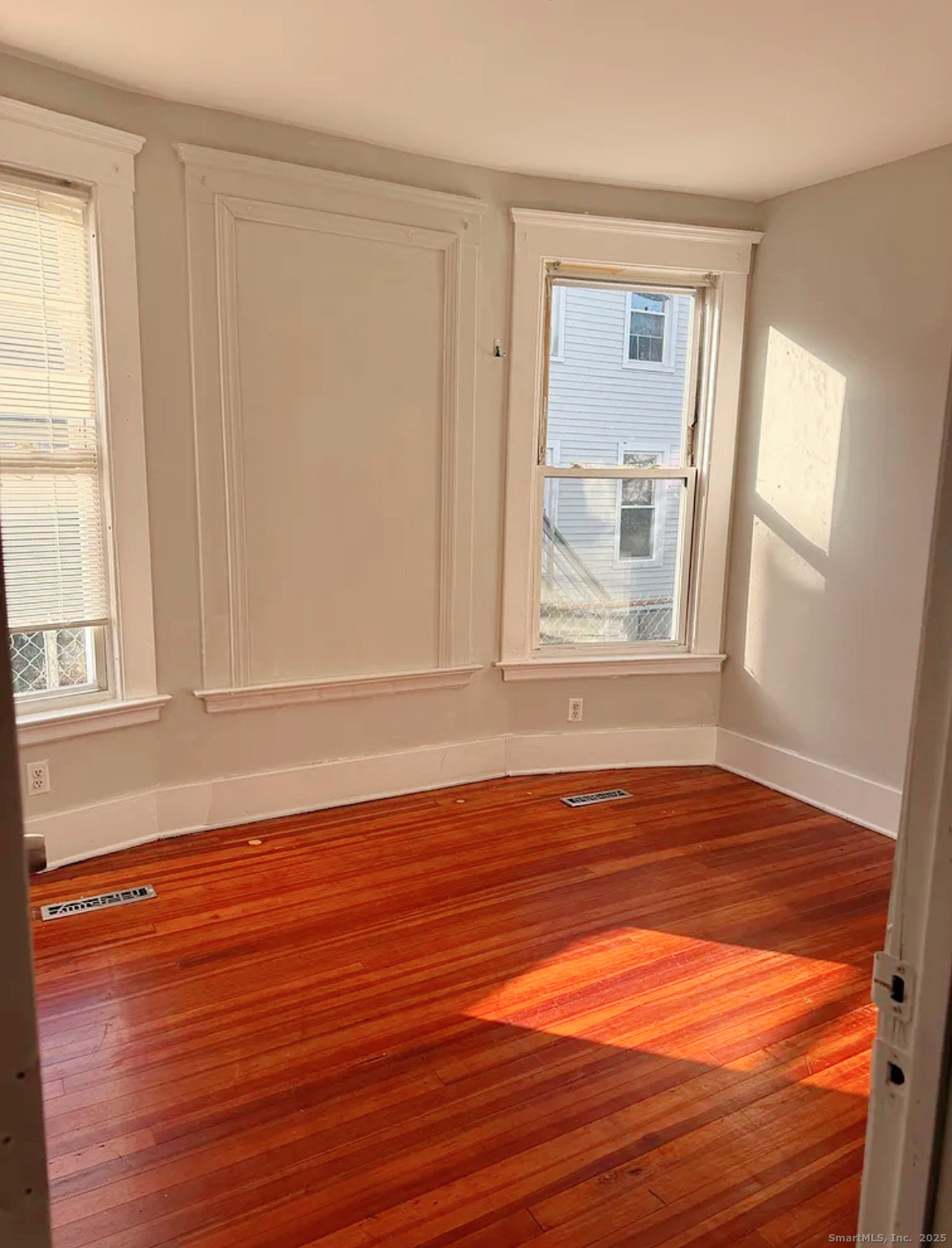 82 1st Street New Haven, CT 06519 - Photo 12 of 40 a view of empty room with wooden floor and fan