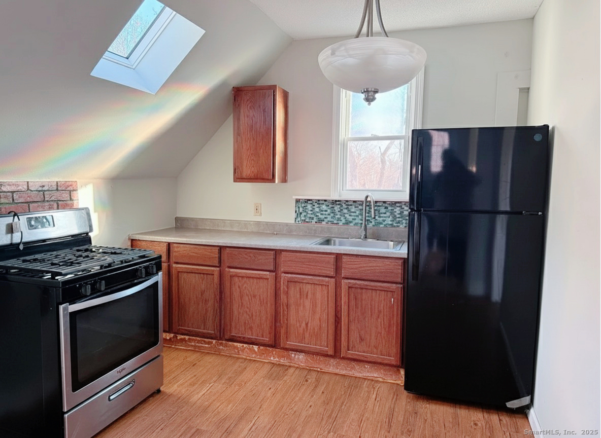 82 1st Street New Haven, CT 06519 - Photo 24 of 40 a kitchen with stainless steel appliances granite countertop a refrigerator a stove a sink and a microwave