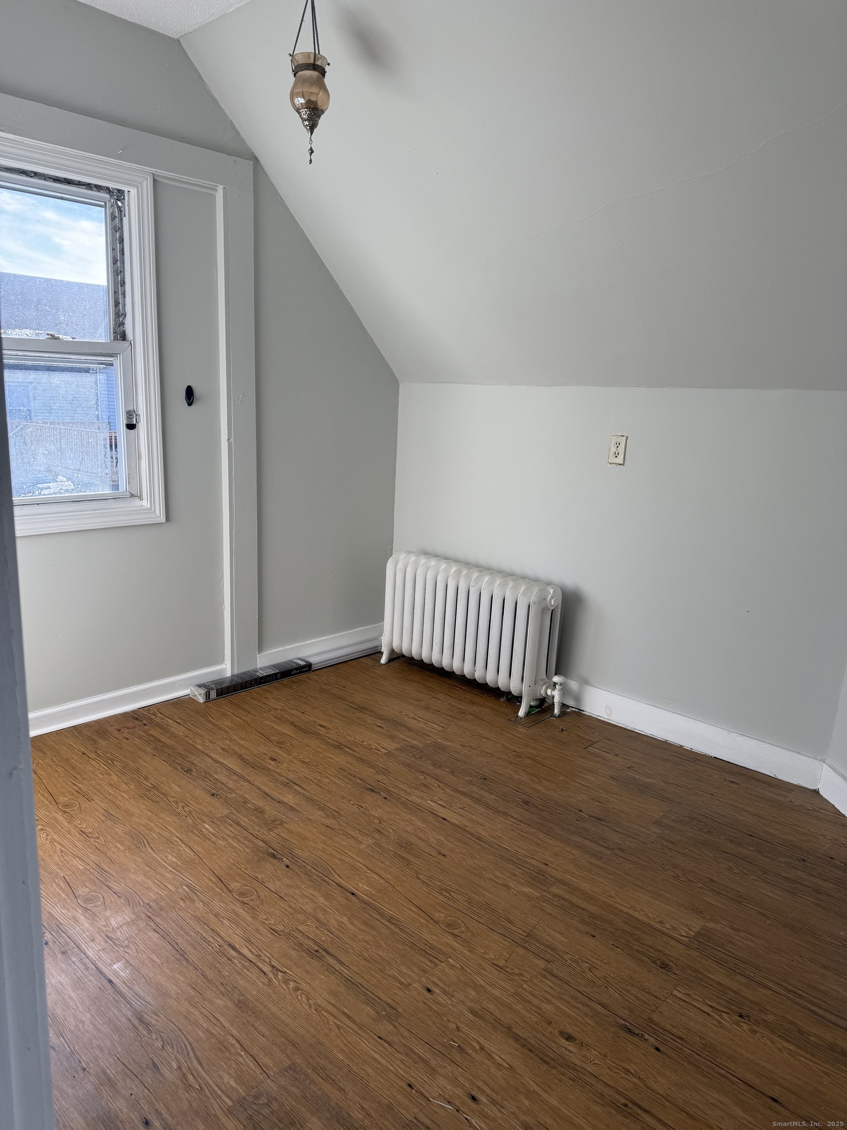82 1st Street New Haven, CT 06519 - Photo 31 of 40 a view of an empty room with wooden floor and a window