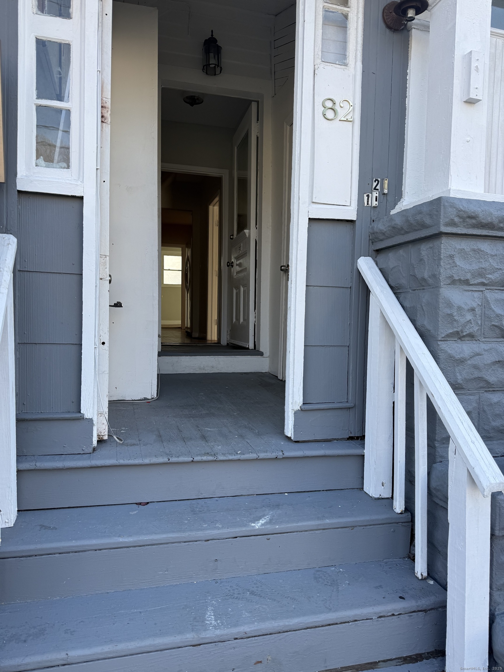 82 1st Street New Haven, CT 06519 - Photo 4 of 40 a view of a hallway with wooden cabinets and staircase