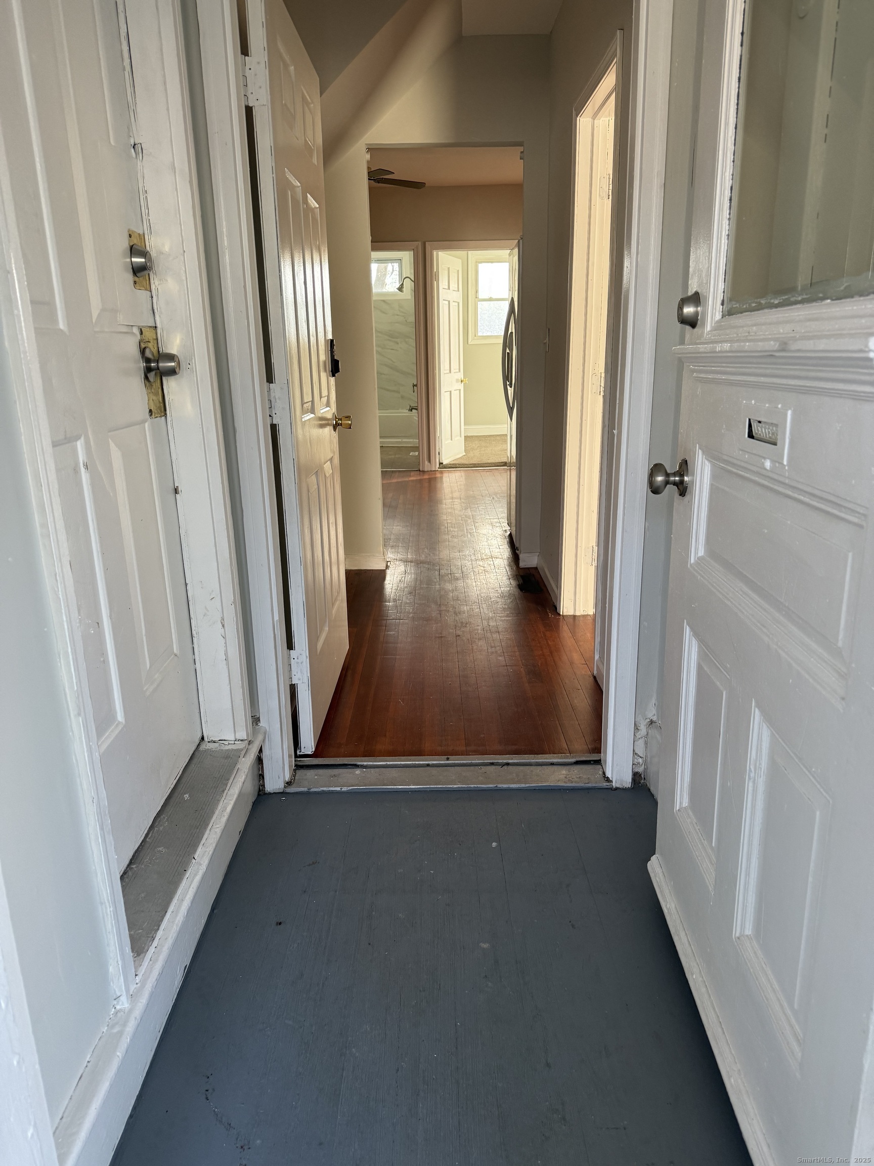 82 1st Street New Haven, CT 06519 - Photo 5 of 40 a view of a hallway with wooden floor and staircase