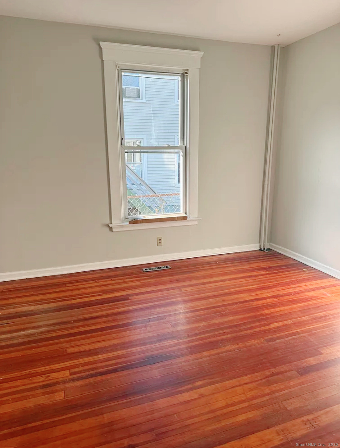 82 1st Street New Haven, CT 06519 - Photo 10 of 40 an empty room with wooden floor and windows