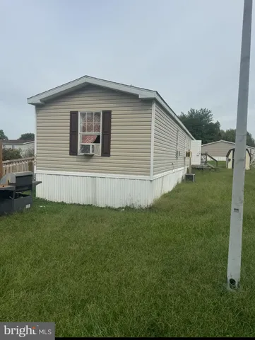 a view of backyard of house with green space