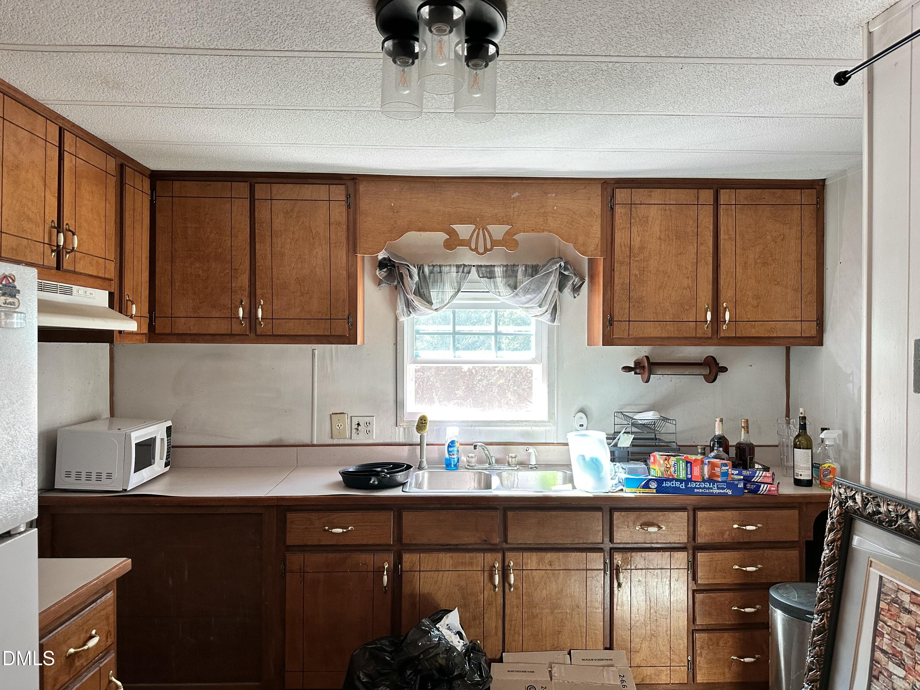 3263 Fleming Graham Road Burlington, NC 27217 - Photo 11 of 15 a kitchen with stainless steel appliances a sink dishwasher window and cabinets