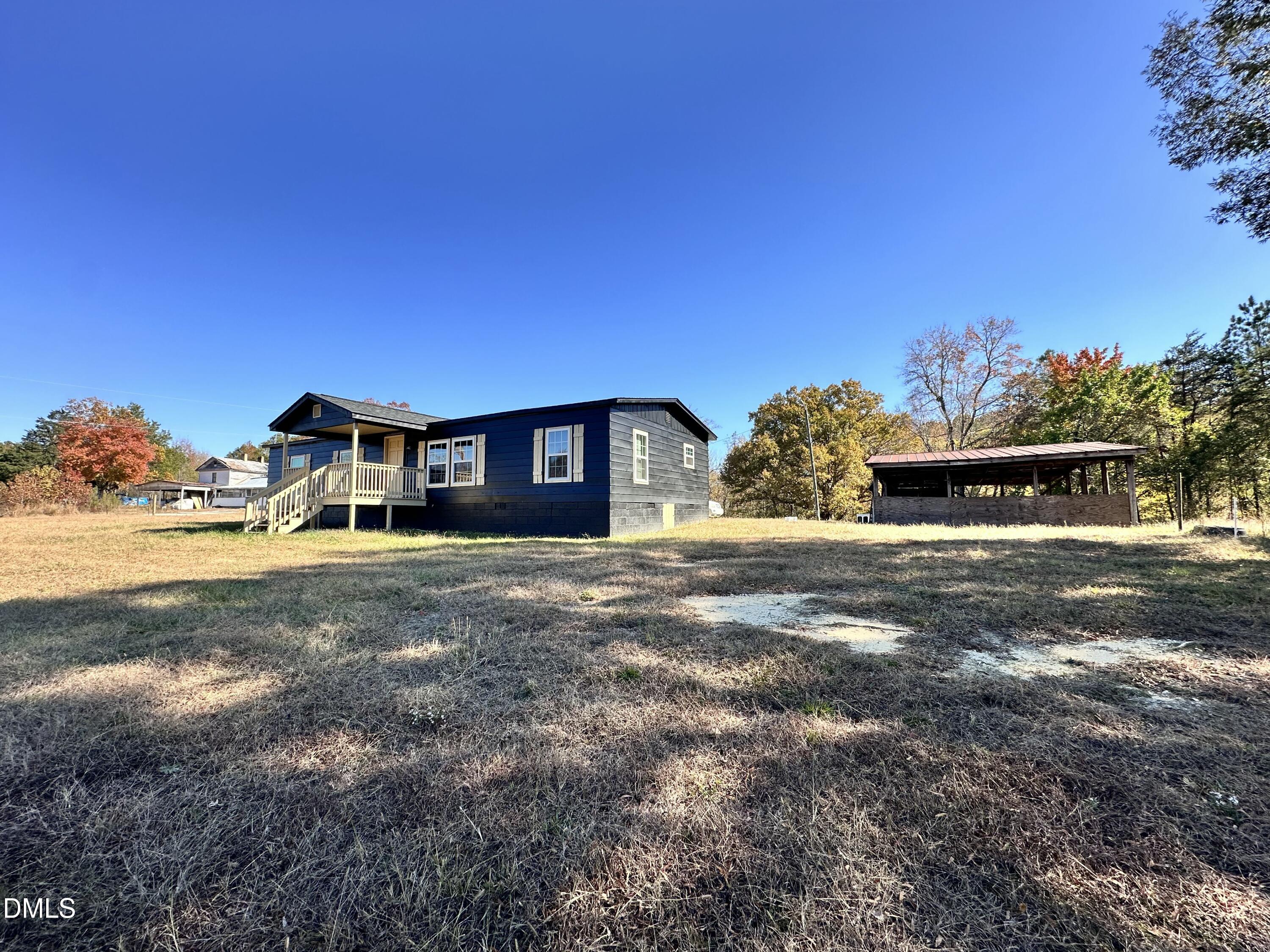 3263 Fleming Graham Road Burlington, NC 27217 - Photo 3 of 15 a front view of a house with large trees