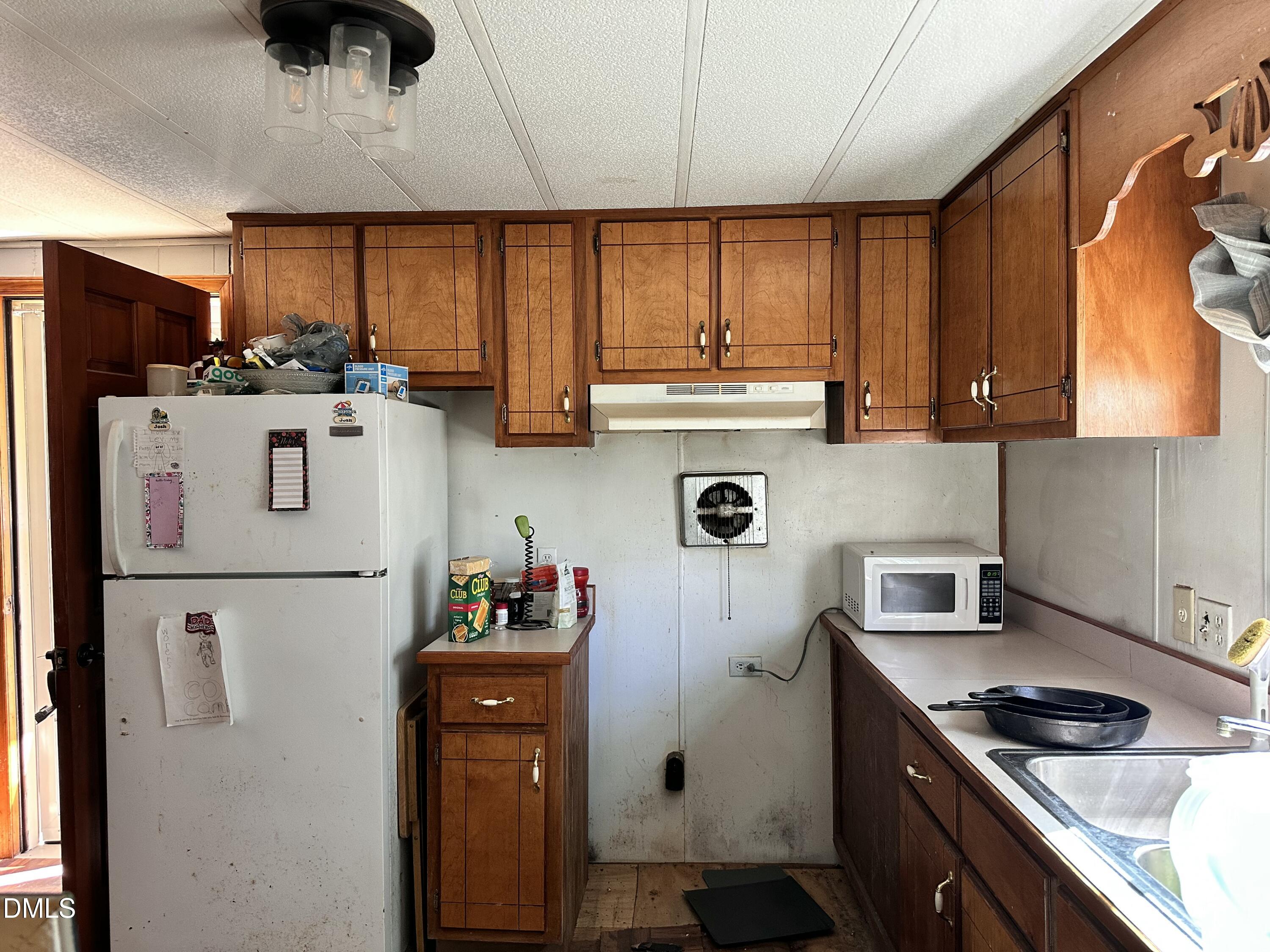 3263 Fleming Graham Road Burlington, NC 27217 - Photo 10 of 15 a kitchen with stainless steel appliances a refrigerator a sink a stove and cabinets