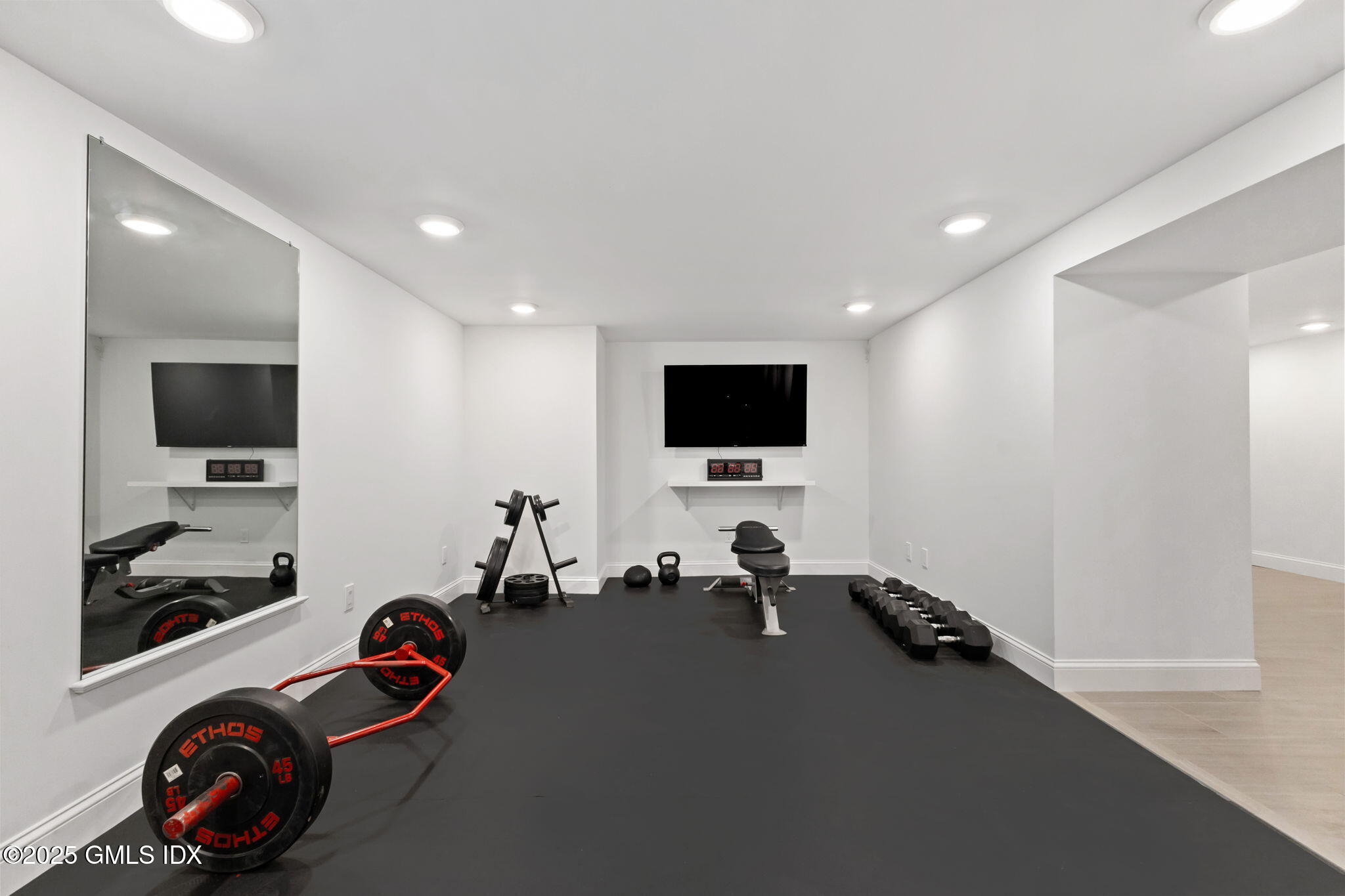 22 Carleton Street Greenwich, CT 06830 - Photo 22 of 26 a view of a room with gym equipment and a flat screen tv