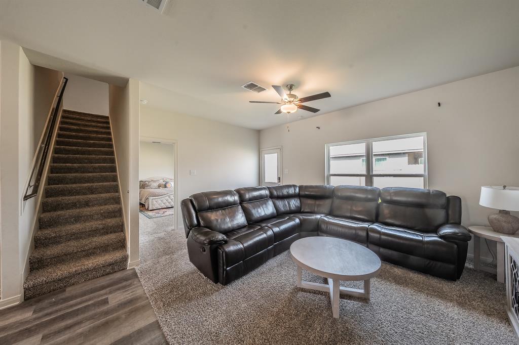 8125 White Sulphur Road Ponder, TX 76259 - Photo 9 of 38 Spacious living area featuring light-toned walls and a ceiling fan with integrated lighting