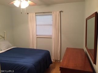 3031 Packinghouse Road Alva, FL 33920 - Photo 22 of 24 a bedroom with a bed and a chandelier
