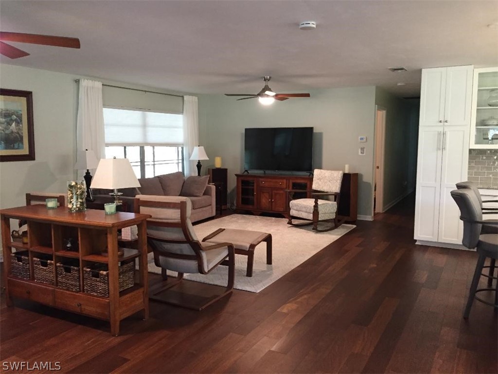 3031 Packinghouse Road Alva, FL 33920 - Photo 4 of 24 a living room with furniture flat screen tv and wooden floor