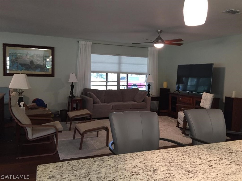 3031 Packinghouse Road Alva, FL 33920 - Photo 6 of 24 a living room with furniture and a flat screen tv