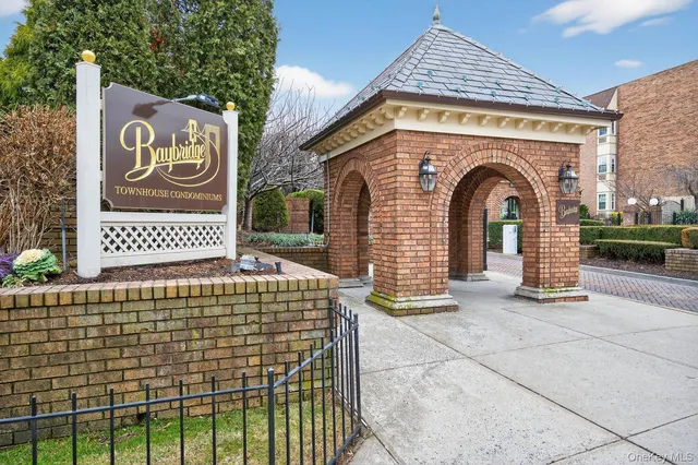 a front view of a house with a sign board