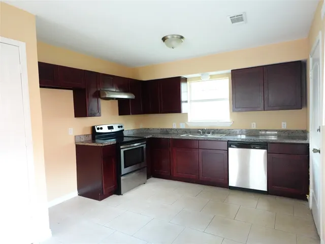 a kitchen with granite countertop stainless steel appliances and cabinets