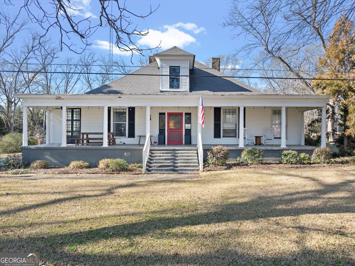a view of a house with a patio next to a yard