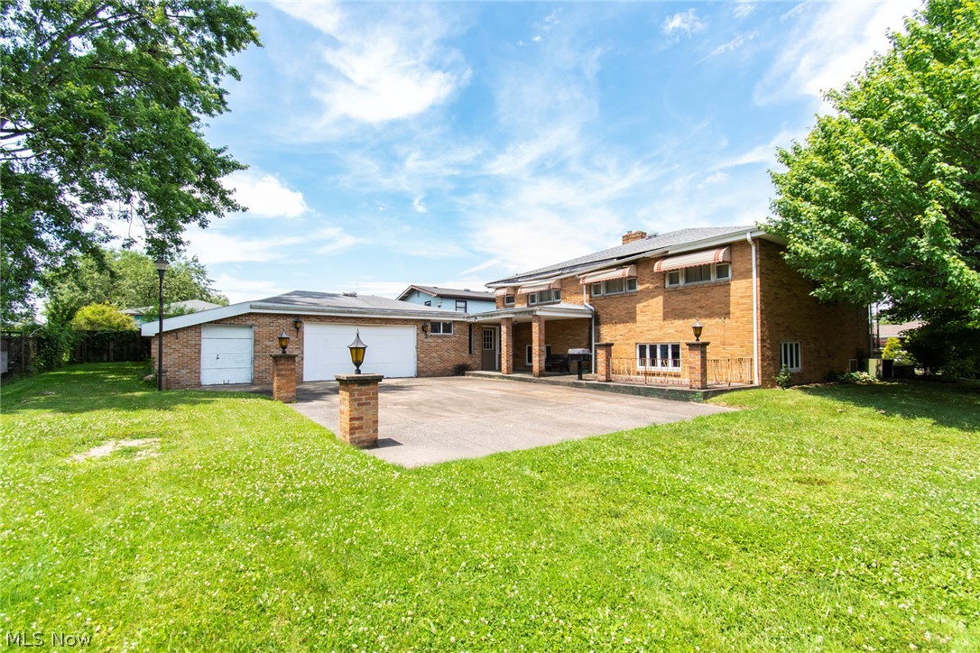 550 Edison Street Struthers, OH 44471 - Photo 19 of 23 Rear view of house with a garage and a yard