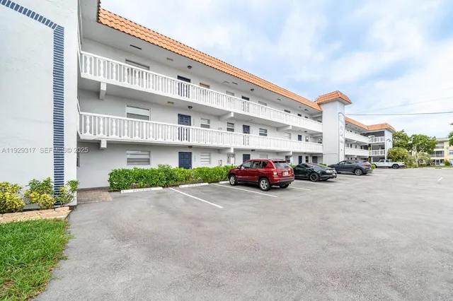 a view of a building with car parked