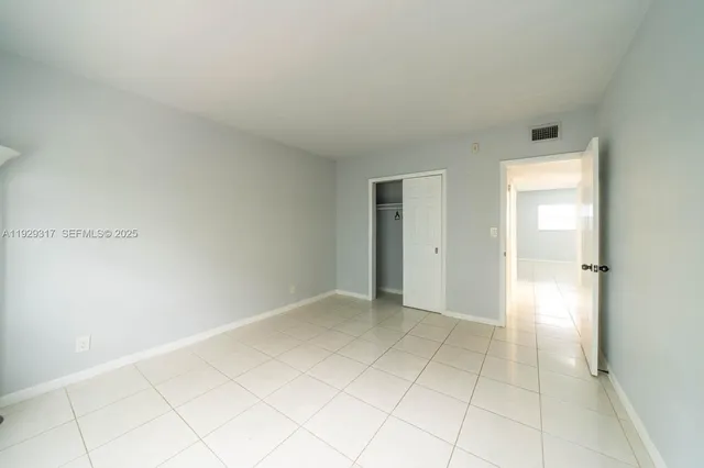 a view of an empty room and closet area