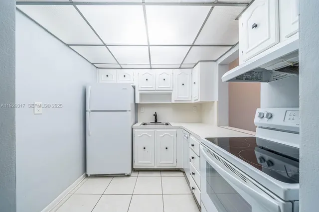 a kitchen with stainless steel appliances a refrigerator sink and cabinets
