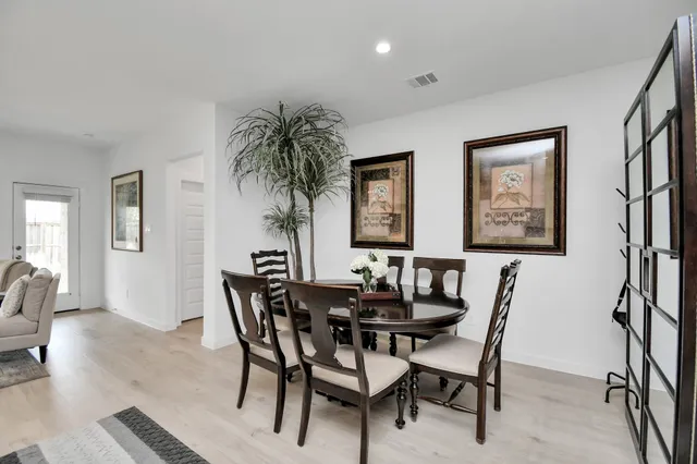 a view of a dining room with furniture and a potted plant
