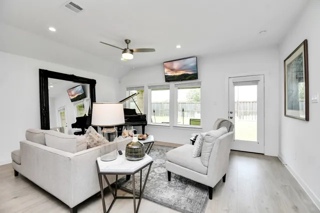 a living room with furniture and a large window