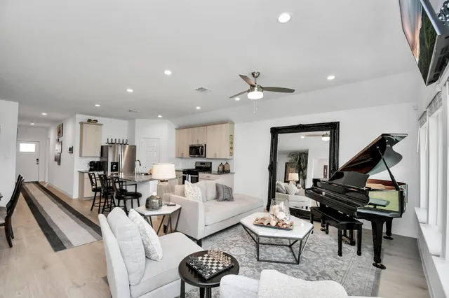 a living room with furniture and wooden floor