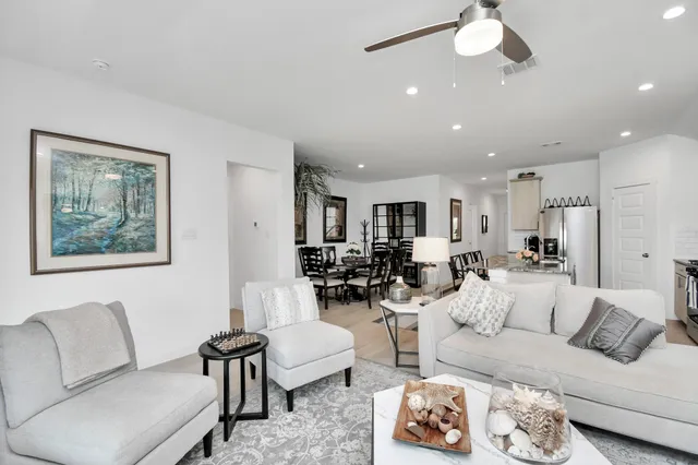 a living room with furniture and a painting