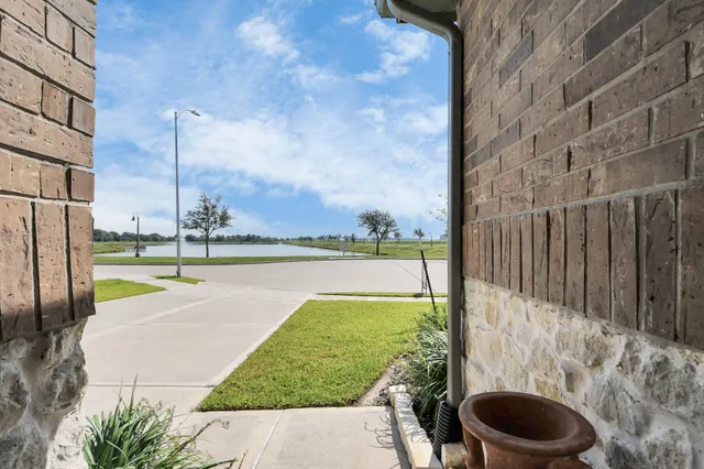a view of a swimming pool and a back yard
