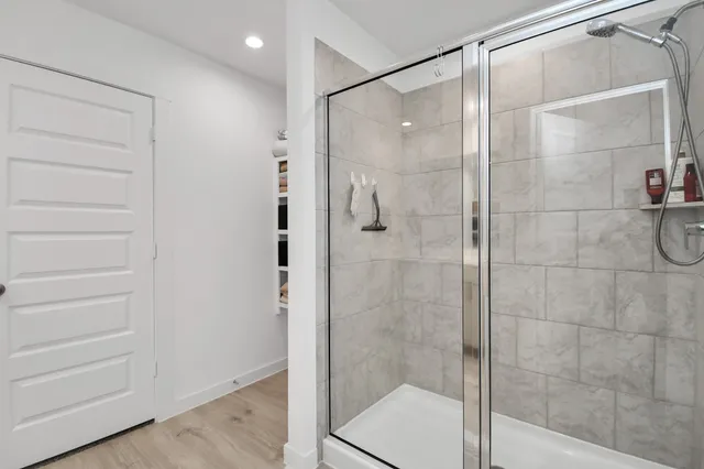 a bathroom that has a glass shower door