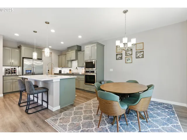 a view of a dining room with furniture and chandelier