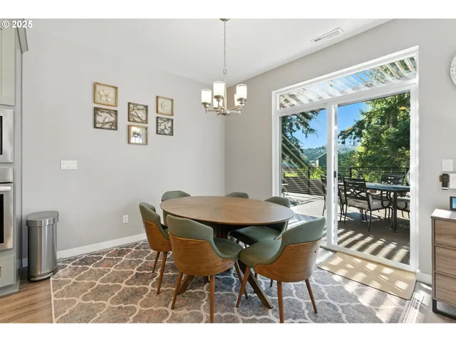 a dining room with furniture a chandelier and window