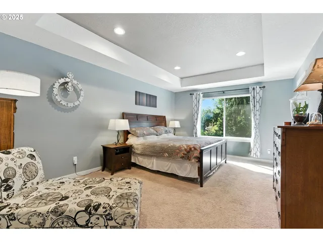 a bedroom with a large bed and a chandelier