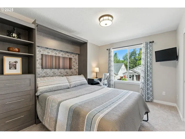 a bedroom with a large bed and a window