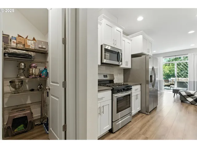 a kitchen with stainless steel appliances a stove a sink and a refrigerator
