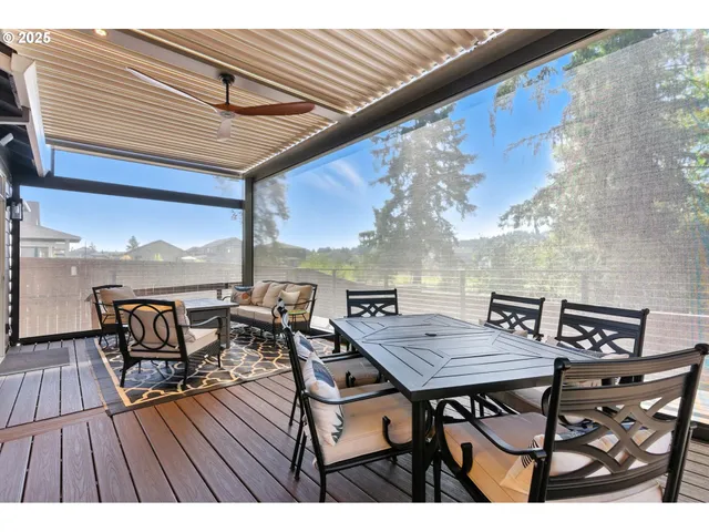 a terrace of a house with wooden floor outdoor seating and city view