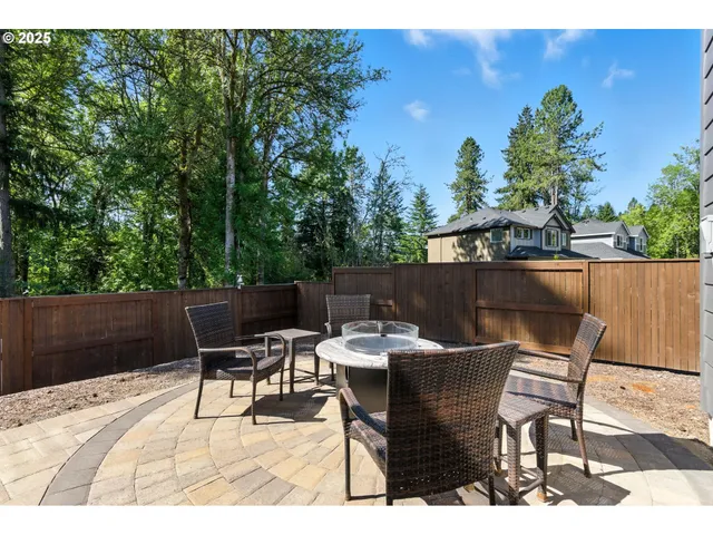 a terrace with outdoor seating and trees