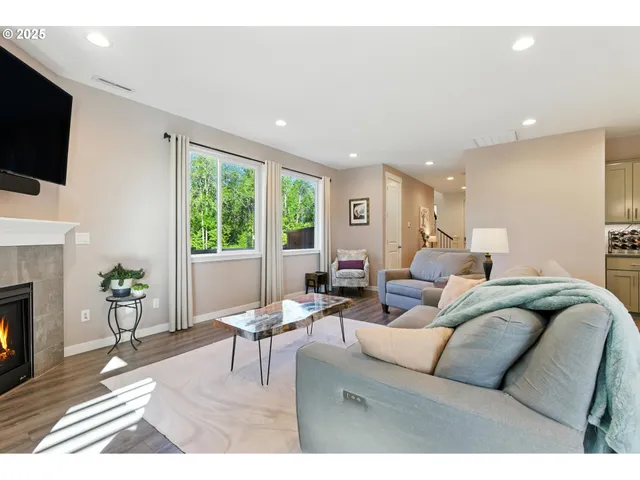 a living room with furniture a fireplace and a flat screen tv