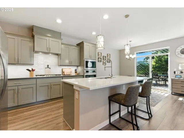 a kitchen with stainless steel appliances kitchen island granite countertop a sink and cabinets