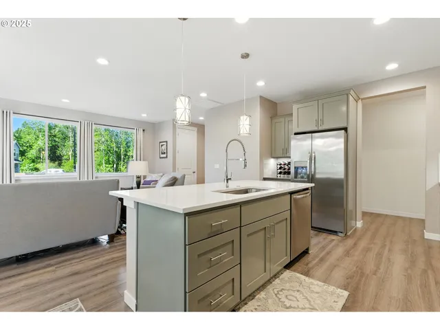 a kitchen with a sink appliances and cabinets
