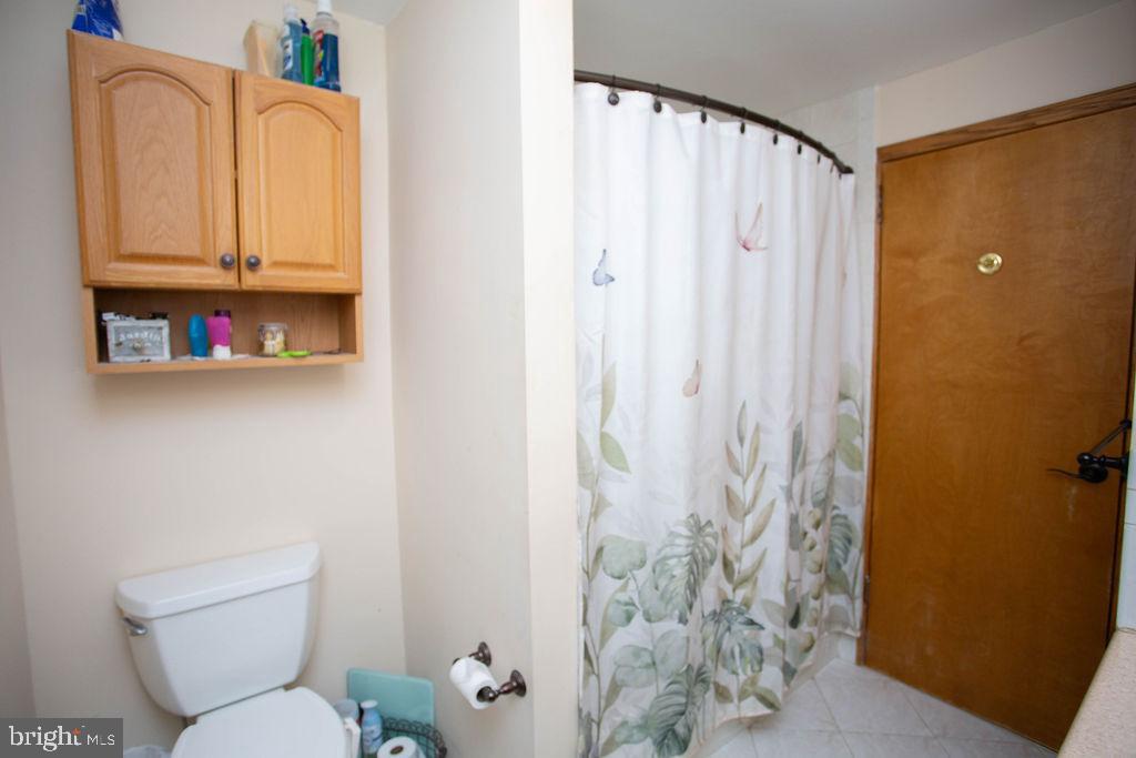 406 Walnut Avenue Laurel Springs, NJ 08021 - Photo 18 of 20 a white toilet sitting next to a shower curtain