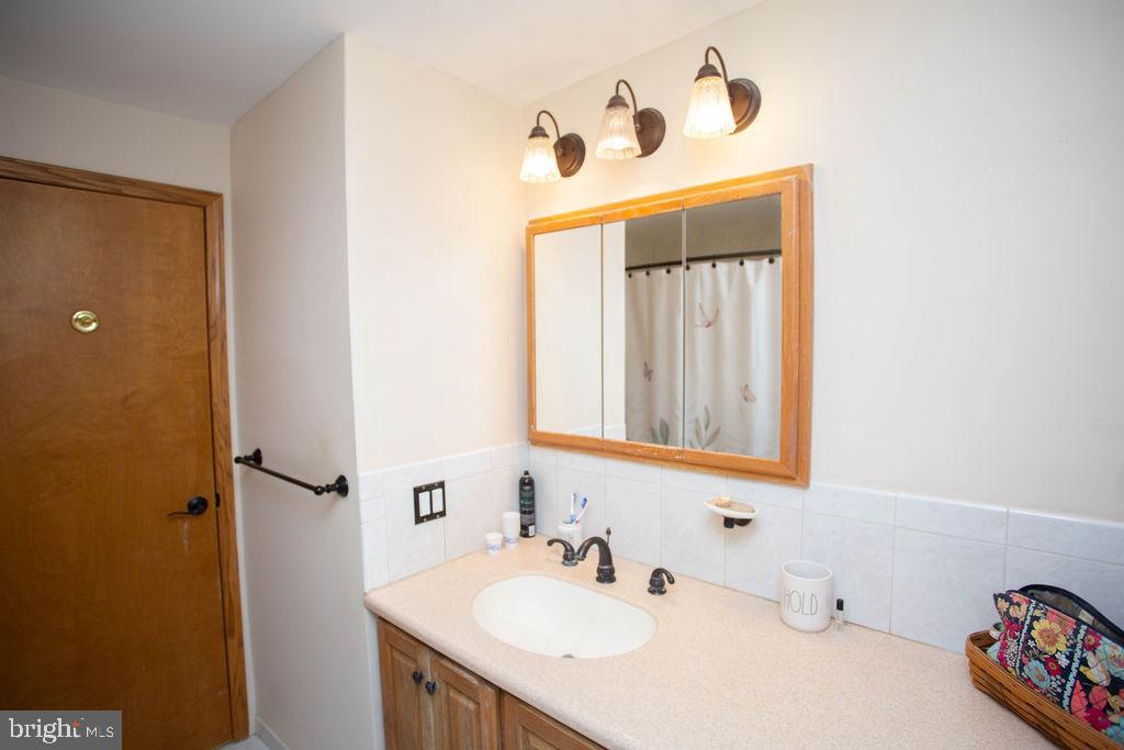 406 Walnut Avenue Laurel Springs, NJ 08021 - Photo 19 of 20 a bathroom with a sink and a mirror
