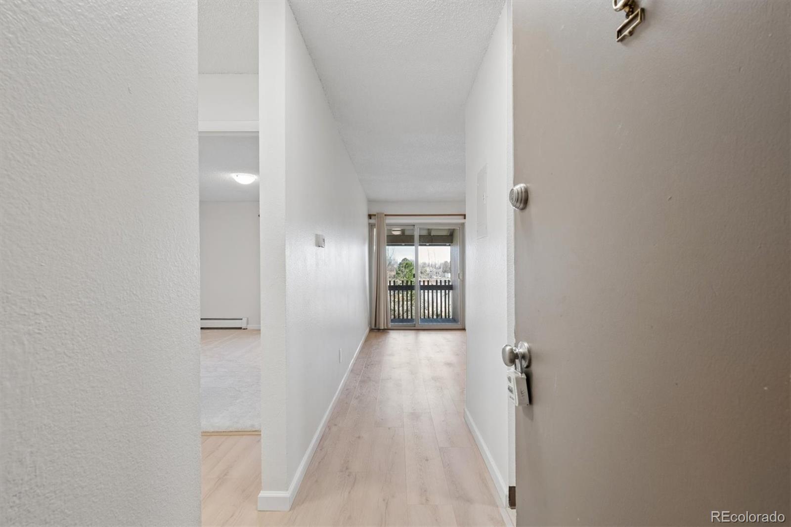 2707 Valmont Road, Unit 312D Boulder, CO 80304 - Photo 15 of 48 a view of a hallway with wooden floor and a bathroom