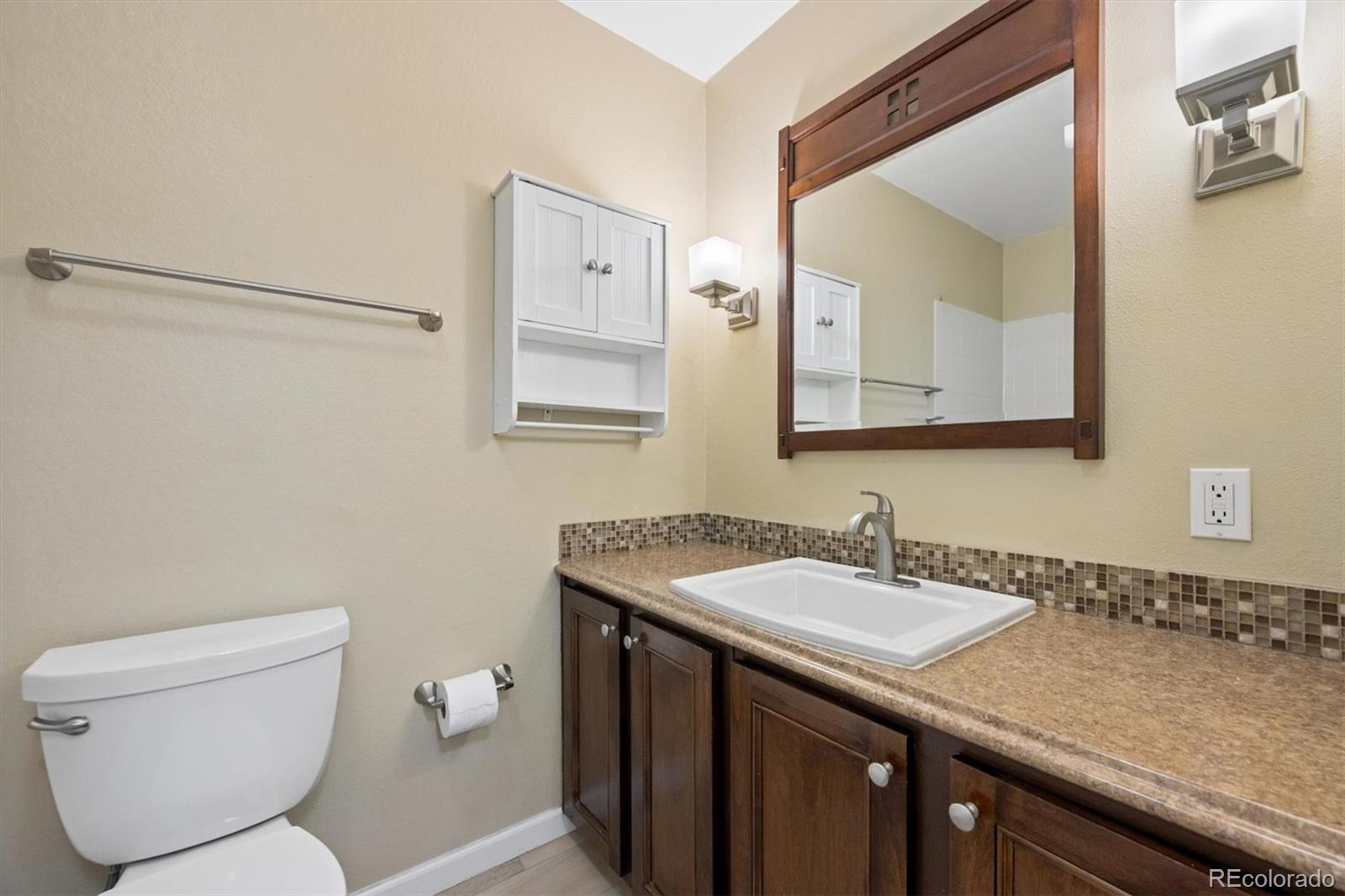 2707 Valmont Road, Unit 312D Boulder, CO 80304 - Photo 23 of 48 a bathroom with a granite countertop sink a toilet and a mirror